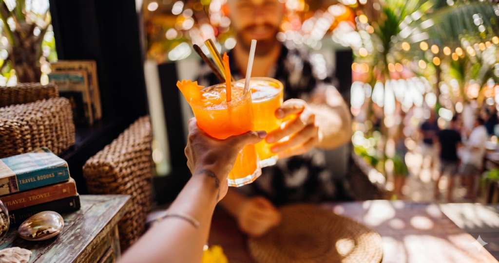 Couple qui trinque avec des cocktails orange